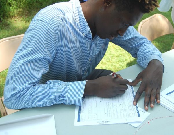 Hussane Yarra completing his Voters' Registration form